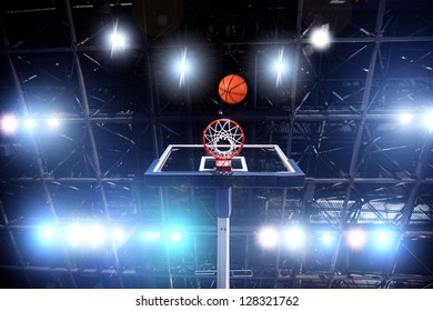 Basket ball heading the hoop with spotlights