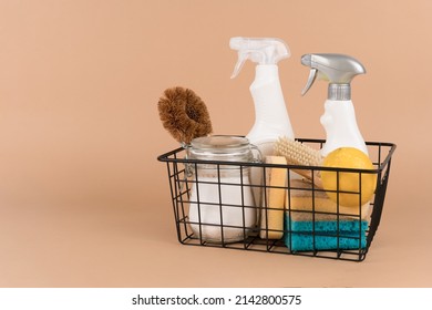 Basket with bio organic detergent products, home cleaning concept. Natural household cleaners - baking soda, lemon, citric acid washer or homemade air fresher on beige background with copy space