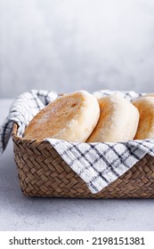 Basket With Black And White Tea Towel Full Of English Muffins