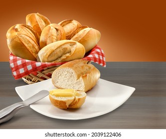 Basket of bread and bread with butter on table background.