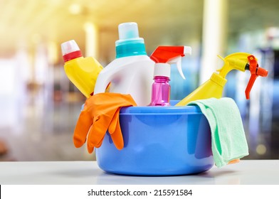 Basket with cleaning items on blurry background