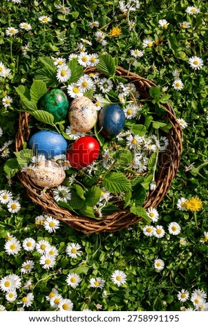 A basket of colorful Easter eggs surrounded by vibrant flowers and green grass, celebrating the joy of spring
