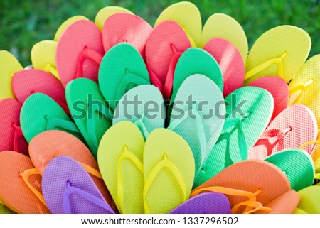 basket with colorful flip-flops