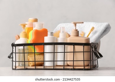 Basket With Cosmetic Products And Bath Accessories On Light Background