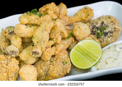 A Basket Of Crispy Chicken Fingers With Platter Of Vegetables And Ranch Dip On A White Plate