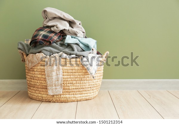 Basket with dirty laundry on\
floor