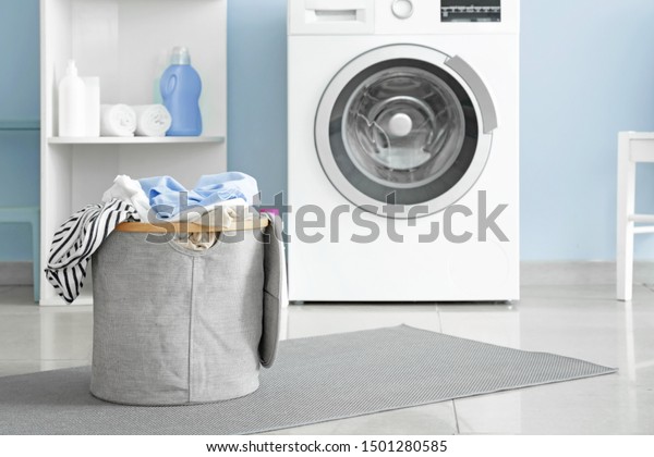 Basket with dirty\
laundry on floor in\
bathroom