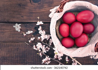 Basket with easter cake and red eggs on rustic wooden table. Top view. - Powered by Shutterstock