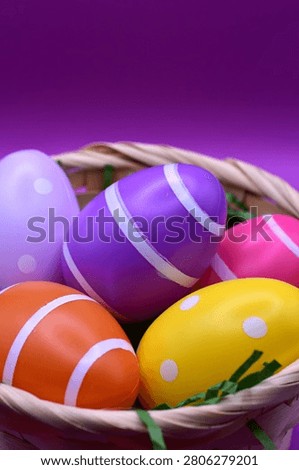 basket with easter eggs on purple background - happy easter 