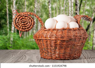 Basket With Eggs On A Birchwood Background