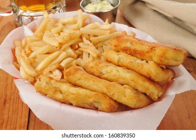 A Basket Of French Fries And Beer Battered Fish Sticks