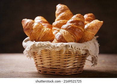 Basket of fresh croissants on wooden background - Powered by Shutterstock