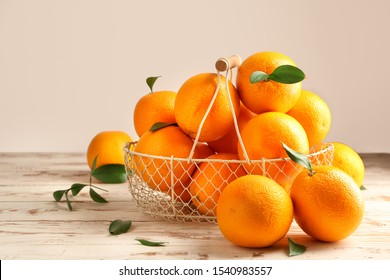 Basket With Fresh Oranges On White Table