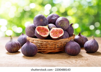 basket of fresh ripe figs fruit on a wooden table