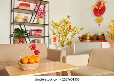 Basket of fresh ripe mandarins on table in living room as a present for Tet - Shutterstock ID 2107601555