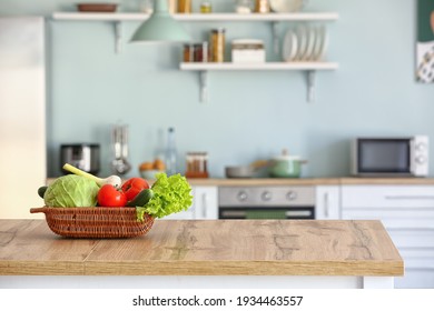 Basket With Fresh Vegetables On Kitchen Table