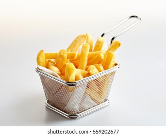Basket of freshly made French fries on white studio background