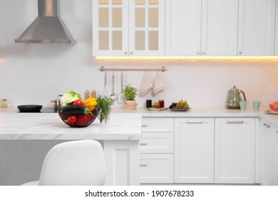 Basket Full Of Different Vegetables On White Table In Modern Kitchen