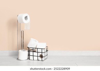 Basket and holder with toilet paper rolls near color wall