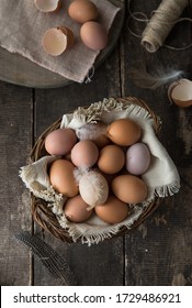 Basket of homemade eggs on wooden table . top view
