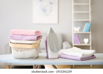 Basket With Laundry And Iron On Board