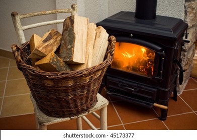 Basket of logs in front a burning fire