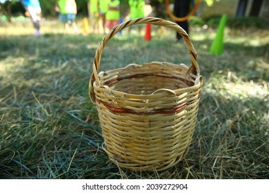 Basket On Grass . Empty Basket Green Meadow . Wicker Picnic Basket On The Fresh Summer Grass Overhead View. Weekend Resting Concept