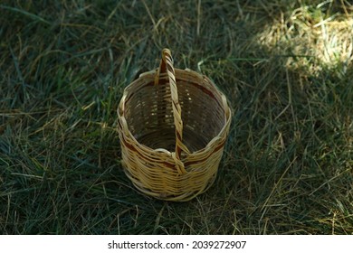 Basket On Grass . Empty Basket Green Meadow . Wicker Picnic Basket On The Fresh Summer Grass Overhead View. Weekend Resting Concept