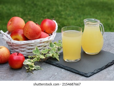 A Basket Of Red Apples And Naturally Cloudy Apple Juice.