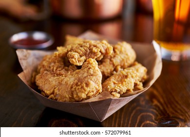 basket of tasty fried chicken tenders - Shutterstock ID 572079961