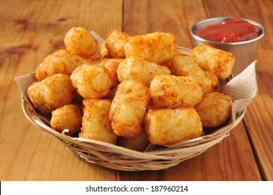 A basket of tater tots on a rustic wooden counter - Shutterstock ID 187960214