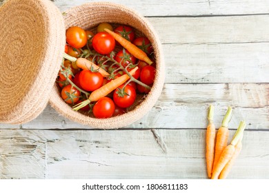 Basket With A Variety Of Baby Carrots And Tomatoes, Including: Cherry, Heirloom And Zebra.