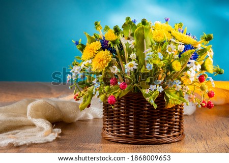 Similar – Image, Stock Photo A bunch of wildflowers in your hand. A bouquet woven from red poppies, blue cornflowers and daisies in full against the sky
