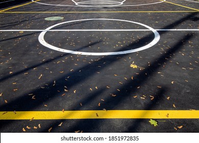 Basketball Area In Circle On The Marking Playing Field With Asphalt Tarmac, Sports  Lit By Sun Light On Playground With Copy Space, Nobody.