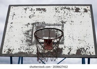 Basketball backboard and basketball hoop with chain net after the rain.