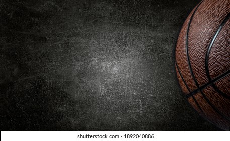 Basketball ball on dark concrete wall texture background. Background for product display, banner, or mockup