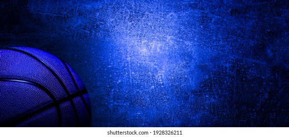 Basketball ball on neon light on concrete wall texture background. Lighting effect blue and red neon background for product display, banner, or mockup
