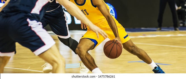 The basketball ball is on the basketball player's hand