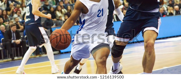 The\
basketball ball is on the basketball player\'s\
hand