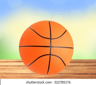 Basketball Ball On The Table Over Bight Nature Background