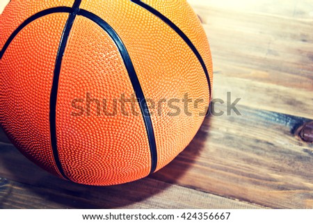 Basketball ball on wooden hardwood floor in the basketball court. Retro vintage picture. Sport concept.