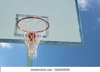 Basketball basket. Backboard basket on cloudy blue sky background.