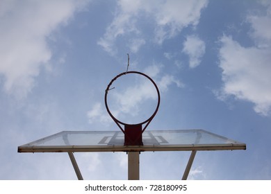 Basketball basket with transparent backboard on beautiful sky