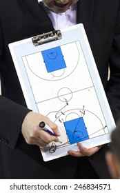 Basketball Coach With Clipboard Explaining Schemes During Timeout