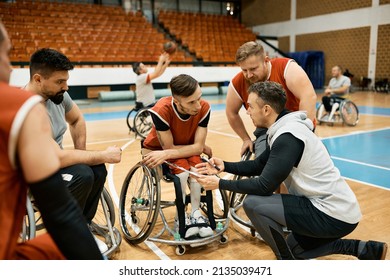 Basketball coach explaining the game plan to his team during wheelchair basketball sports training. - Powered by Shutterstock