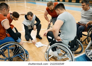 Basketball Coach And His Team With Disabilities Discussing About Game Strategy During Sports Training. 