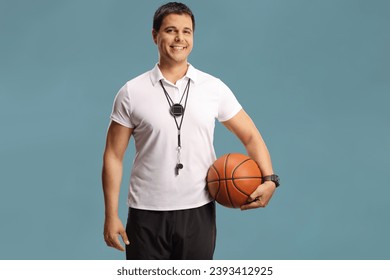 Basketball coach holding a ball isolated on blue background

 - Powered by Shutterstock