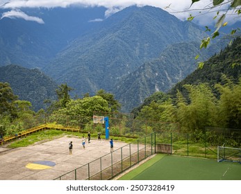 A basketball court perched on a mountainside, with players enjoying a game amidst breathtaking scenery. Misty mountains create a dramatic backdrop.
 - Powered by Shutterstock