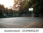 Basketball court, sports and outdoor ground for game, competition or training area with trees. Fitness, exercise and concrete arena for recreation, workout or community with asphalt, net or backboard