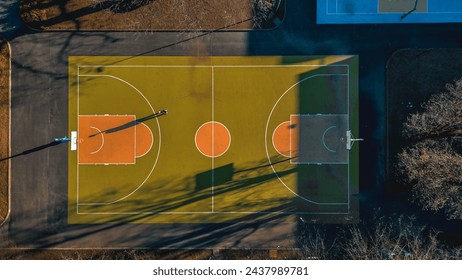Basketball court top down view. The concept of sport and healthy lifestyle. Basketball player throws the ball into the basket. High quality aerial photo